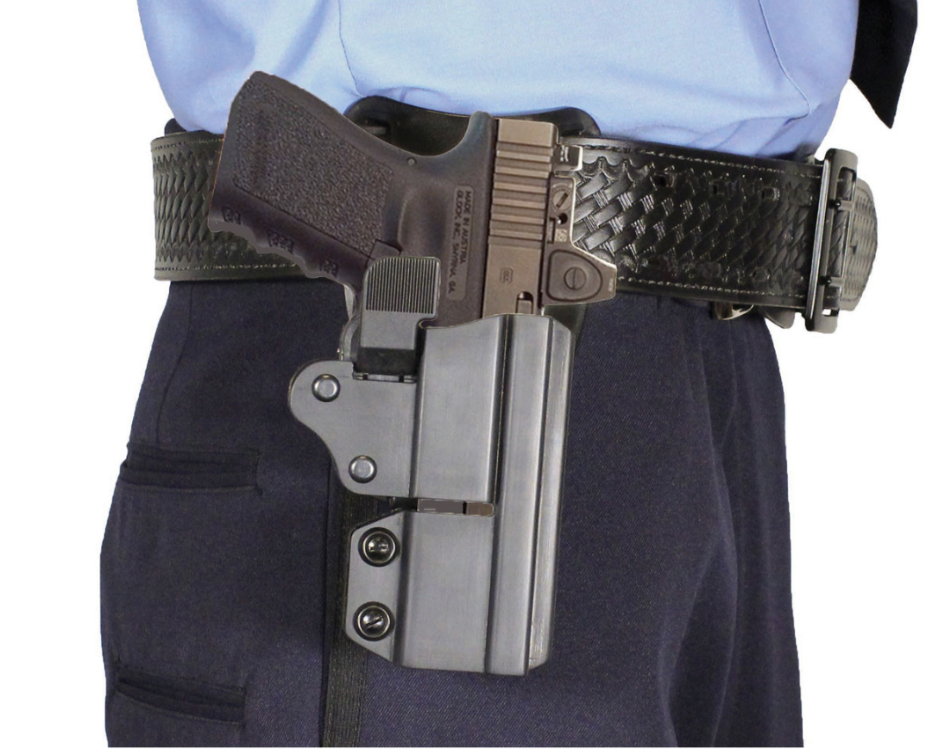 Close-up image showing a handgun secured in a holster attached to a tactical duty belt, illustrating proper firearm carry equipment and belt setup.
